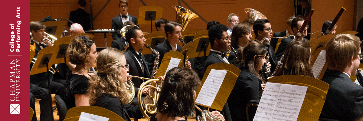 Chapman University College of Performing Arts. Student musicians seated reading their sheet music and playing instruments.