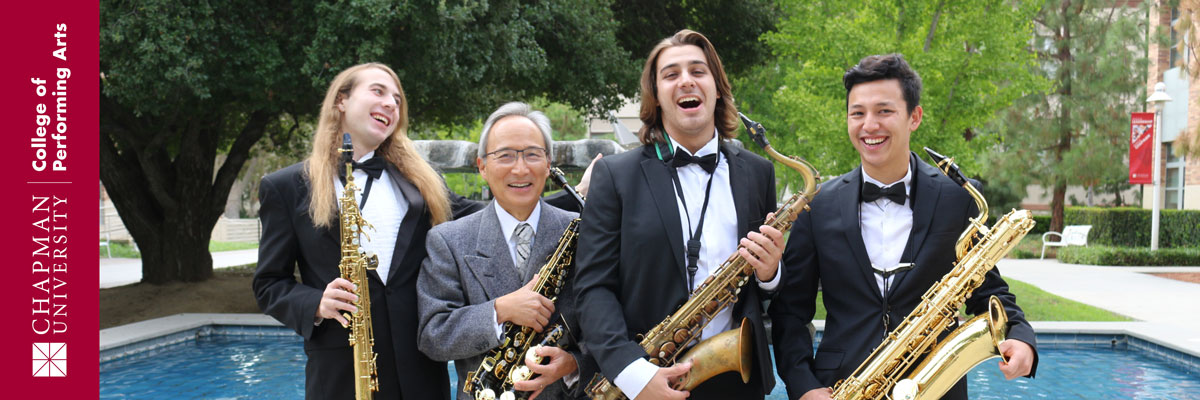 Chapman University College of Performing Arts | Four dressed up saxophone players hold their instruments in front of a fountain.