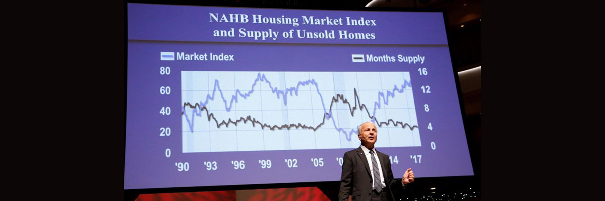 Picture of Dr. James L. Doti presenting in front of a screen that shows a previous NAHB Housing Market Index and Supply of Unsold Homes